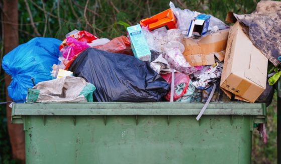 This stock image shows a full dumpster.