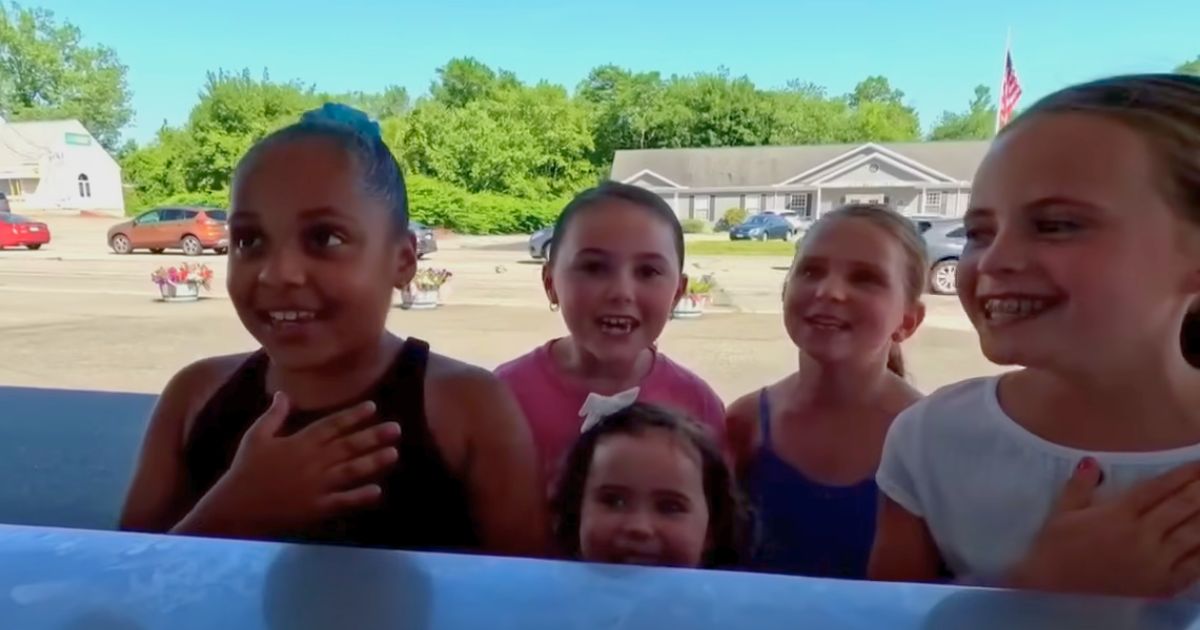 Children recite the Pledge of Allegiance at the Eskimo King ice cream shop in Swansea, Massachusetts.