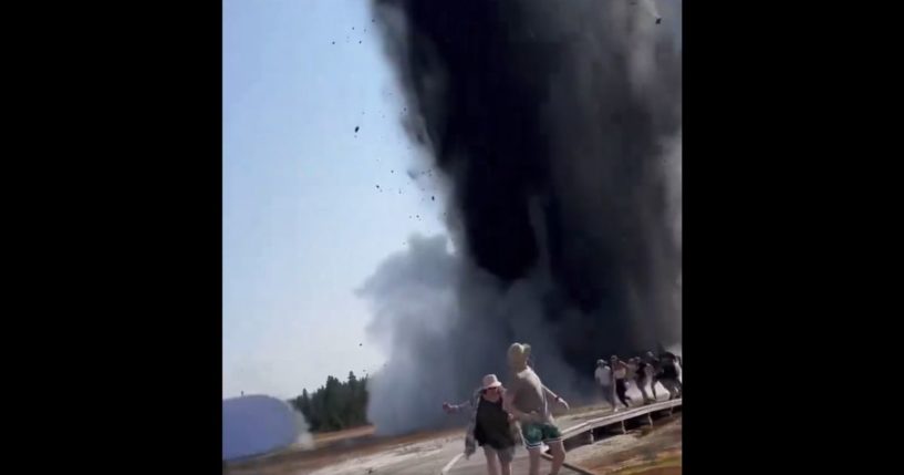 Parkgoers run from debris at Biscuit Basin in Yellowstone National Park.