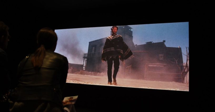 Visitors watch a clip of the film "A Fistful of Dollars" at the Cinémathèque Française in Paris on Oct. 8, 2018.