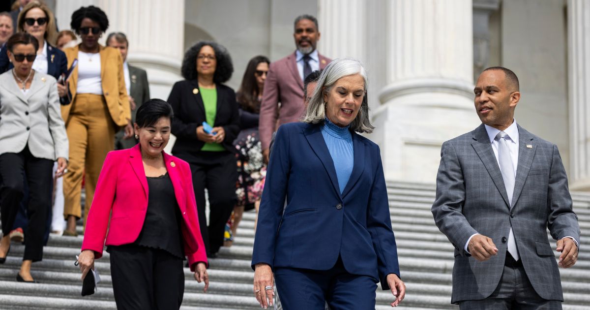 House Minority Leader Hakeem Jeffries and Democratic Whip Katherine Clark walks down the steps of the Capitol with other House Democrats on Thursday in Washington.