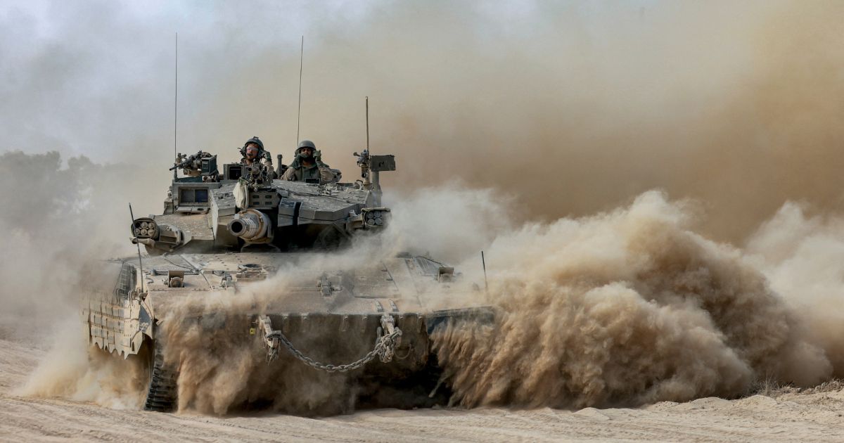 Israeli soldiers sit in the turret of a moving main battle tank at a position along the border with the Gaza Strip and southern Israel on Sunday.