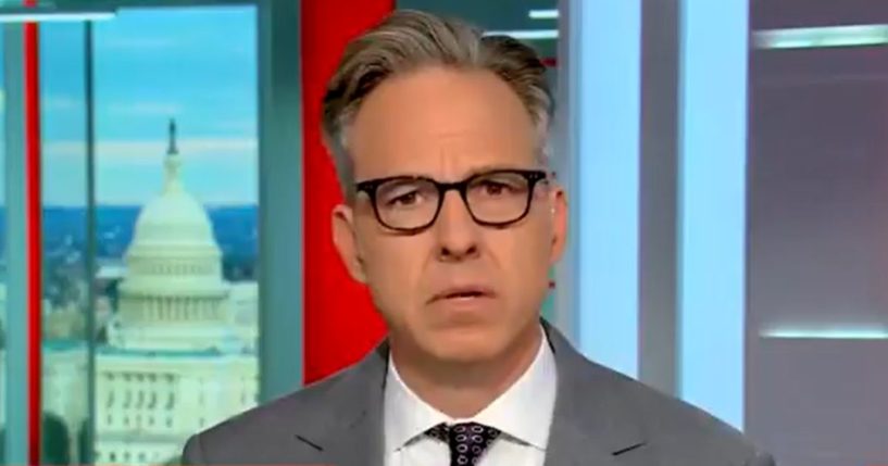 Jake Tapper reacts after reading a quote from President Joe Biden.