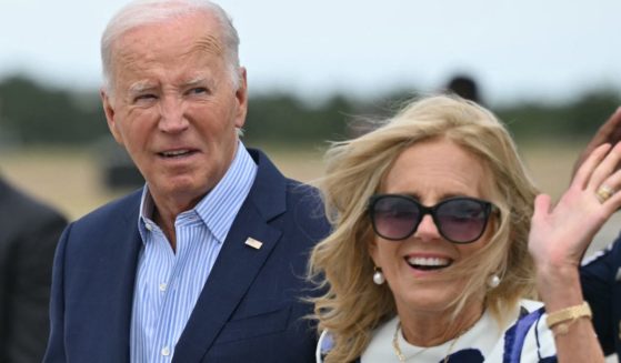 First lady Jill Biden, right, waves after stepping off Air Force One upon arrival at Francis S. Gabreski Airport in Westhampton Beach, New York, on Saturday.