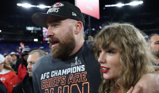 Travis Kelce of the Kansas City Chiefs celebrates a playoff victory with Taylor Swift at M&T Bank Stadium in Baltimore on Jan. 28.