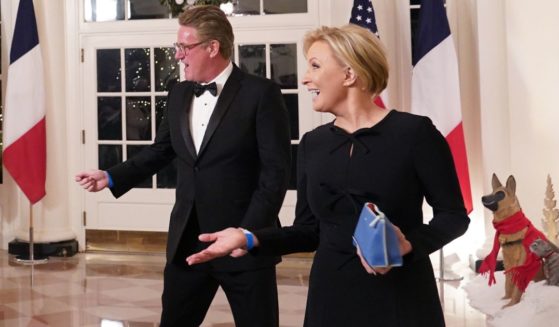 MSNBC television hosts Joe Scarborough, left, and Mika Brzezinski, right, arrive for the White House state dinner for French President Emmanuel Macron at the White House in Washington, D.C., on Dec. 1, 2022.