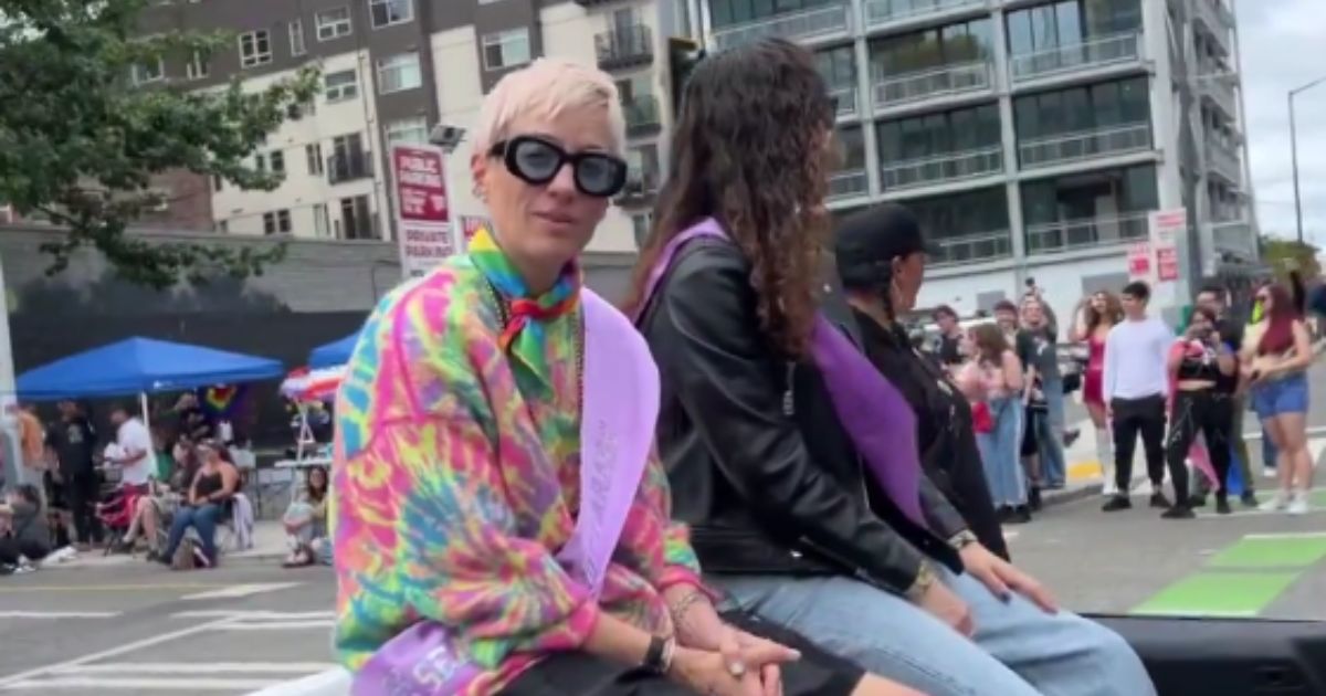 Former U.S. women's soccer player Megan Rapinoe, left, was confronted about her stance on transgender "women" playing in girls' sports during a "pride" event in Seattle on Sunday.