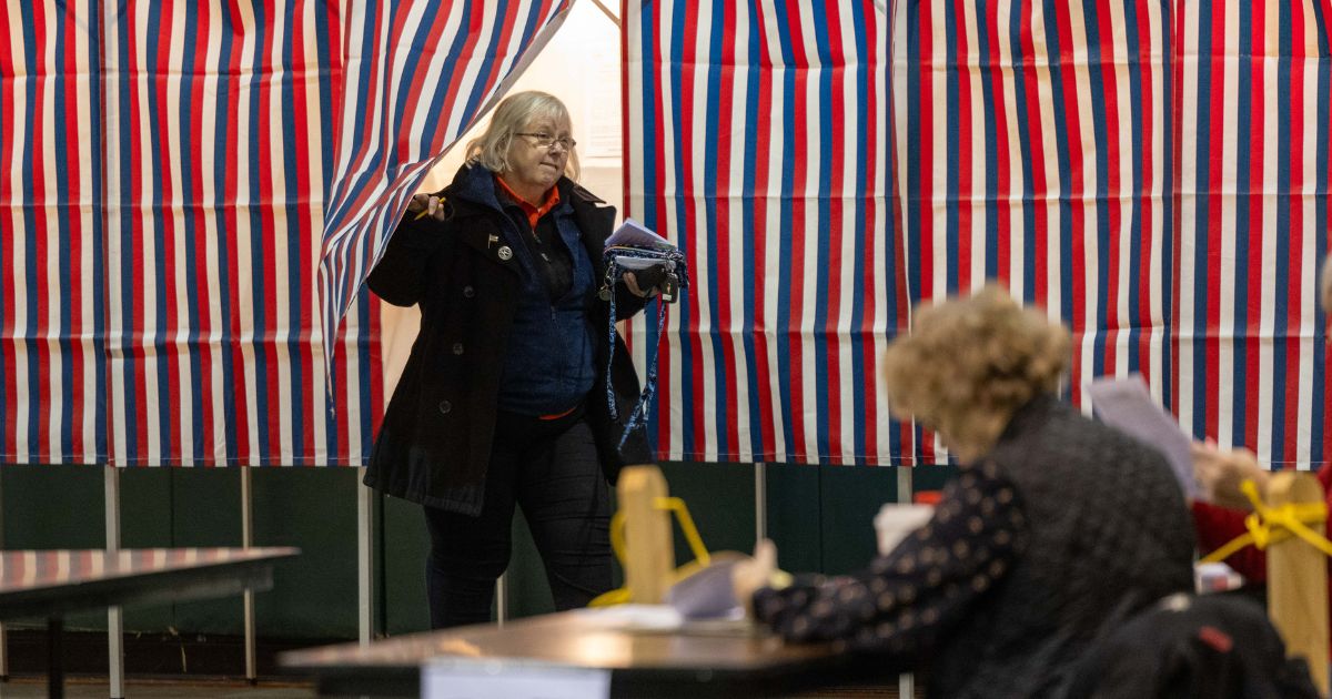 A voter leaves a voting booth after filling out a ballot at a polling location.