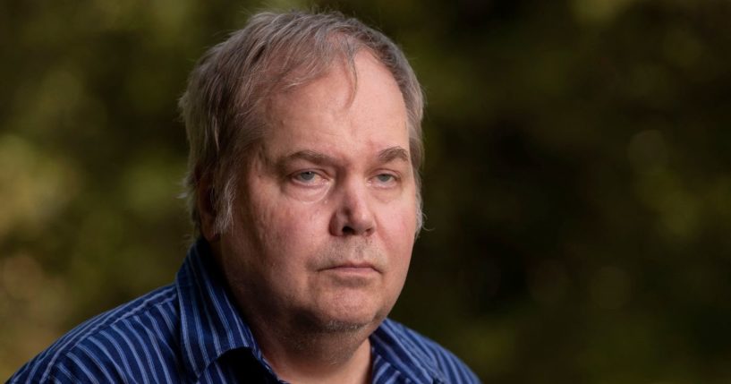 John Hinckley Jr. stands for a portrait in 2022.