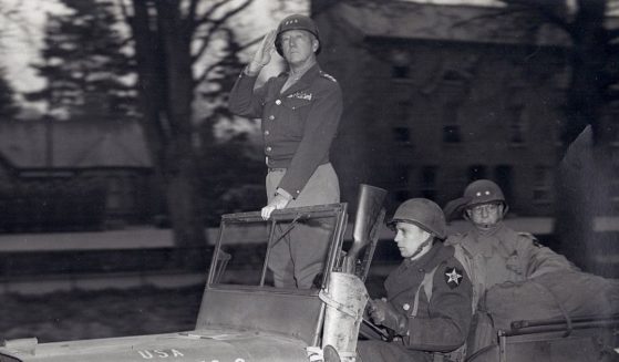 Lt. Gen. Patton with Maj. Gen. Walter Robertson pass in review of Third Army Troops in April 1944.