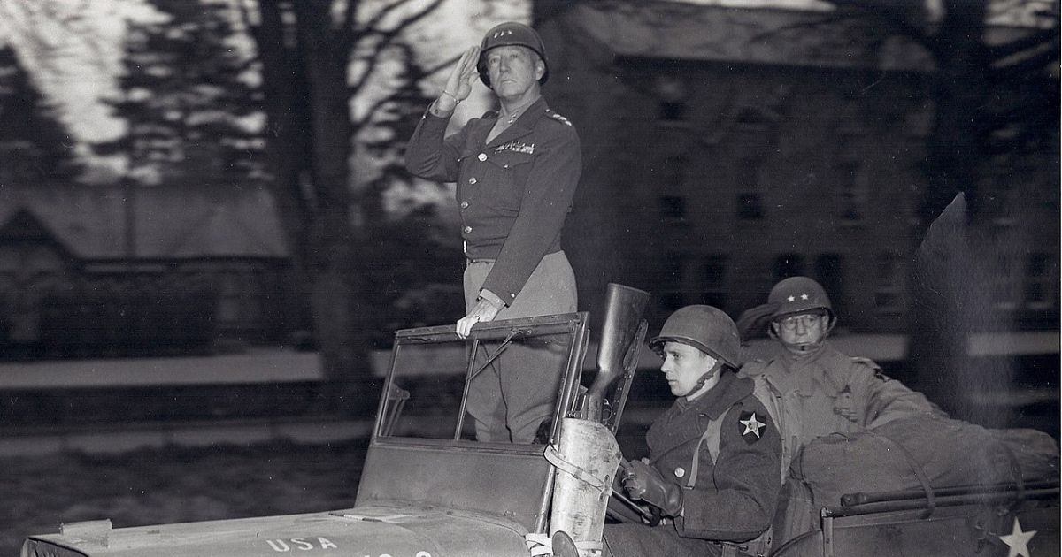 Lt. Gen. Patton with Maj. Gen. Walter Robertson pass in review of Third Army Troops in April 1944.