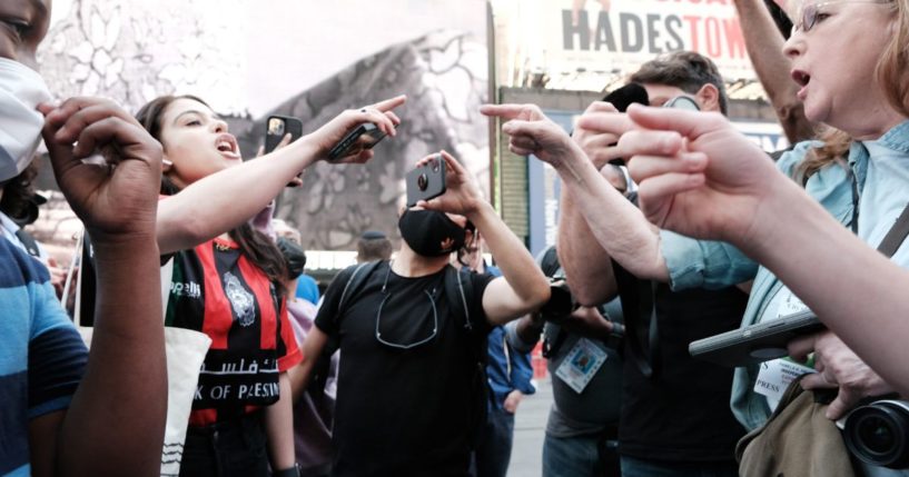 Pro Palestinian protesters face off with a group of Israel supporters and police in a violent clash in Times Square on May 20, 2021 in New York City.