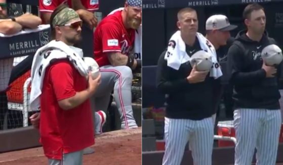 On the Fourth of July the game between the Cincinnati Reds and New York Yankees was nearly delayed when Reds pitcher Graham Ashcraft, left, got into a "national anthem standoff" with Yankees pitchers Cody Poteet and Ian Hamilton, right.
