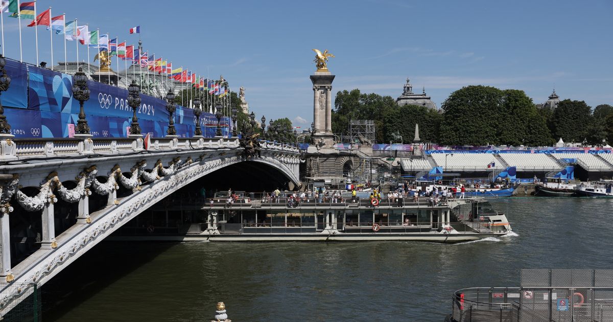 A tourist boat navigates on the Seine river under the Alexandre III bridge, after the first triathlon training session was cancelled during the Paris 2024 Olympic Games in Paris, on Sunday.