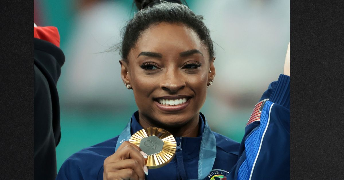 Simone Biles of Team USA celebrates on the podium during the medal ceremony for the Artistic Gymnastics Women's Team Final on day four of the Olympic Games Tuesday in Paris, France.