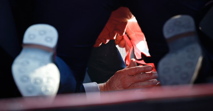 Secret Service tend to Republican presidential candidate and former President Donald Trump onstage after he was shot during a rally in Butler, Pennsylvania, on Saturday.