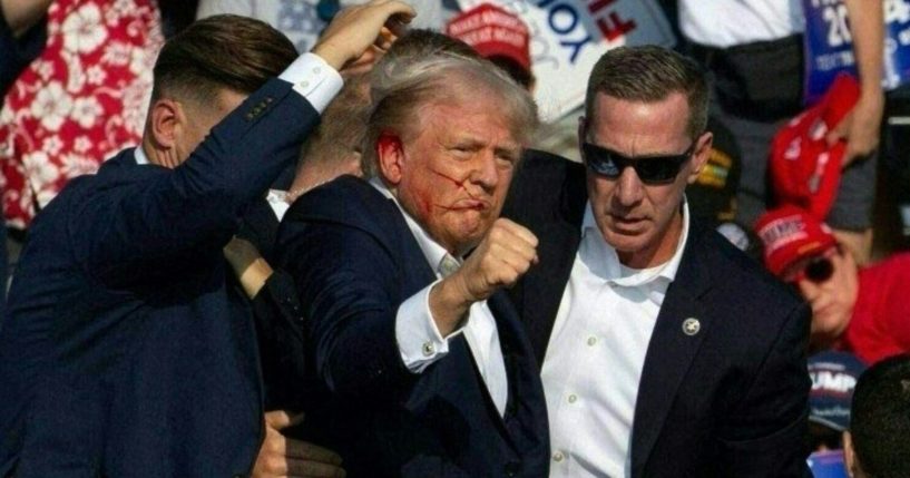 Former President Donald Trump is escorted off stage by Secret Service after being shot in the ear at a rally in Butler, Pennsylvania, on July 13.