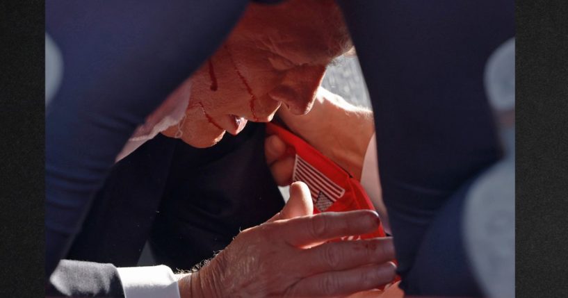 Secret Service tend to an injured former President Donald Trump onstage after a shooting at a rally Saturday in Butler, Pennsylvania.