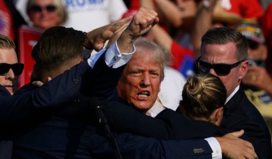 Secret Service agents surround Republican presidential candidate and former President Donald Trump onstage after he was shot at a rally in Butler, Pennsylvania, on Saturday.