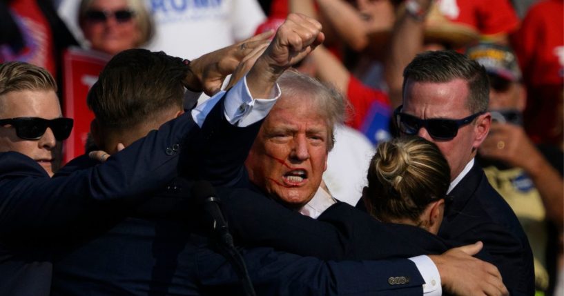 Secret Service agents surround Republican presidential candidate and former President Donald Trump onstage after he was shot at a rally in Butler, Pennsylvania, on Saturday.