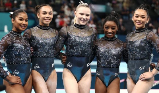 Members of the U.S. women's gymnastics team, from left, Jordan Chiles, Hezly Rivera, Jade Carey, Simone Biles and Sunisa Lee pose for a photo Sunday in Paris, France.