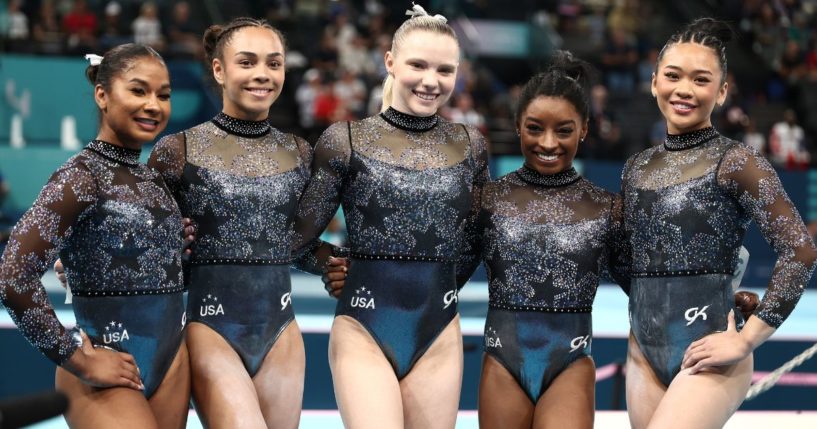 Members of the U.S. women's gymnastics team, from left, Jordan Chiles, Hezly Rivera, Jade Carey, Simone Biles and Sunisa Lee pose for a photo Sunday in Paris, France.