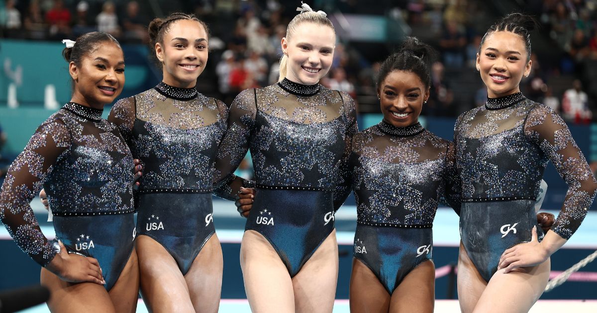 Members of the U.S. women's gymnastics team, from left, Jordan Chiles, Hezly Rivera, Jade Carey, Simone Biles and Sunisa Lee pose for a photo Sunday in Paris, France.