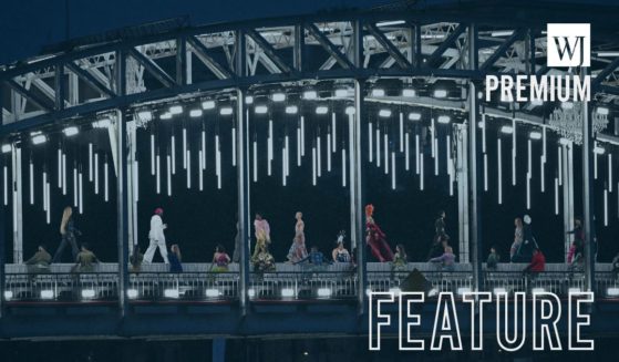 Models walk on a catwalk in front of a tableau of "The Last Supper" on the Passerelle Debilly bridge in Paris, France, on Friday.