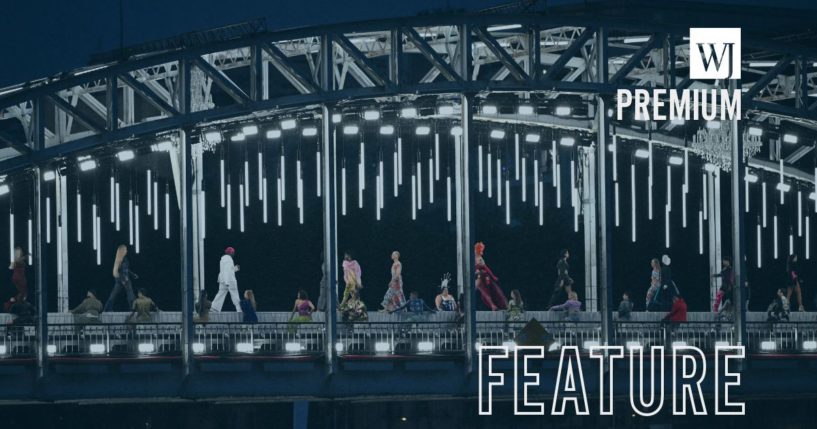 Models walk on a catwalk in front of a tableau of "The Last Supper" on the Passerelle Debilly bridge in Paris, France, on Friday.