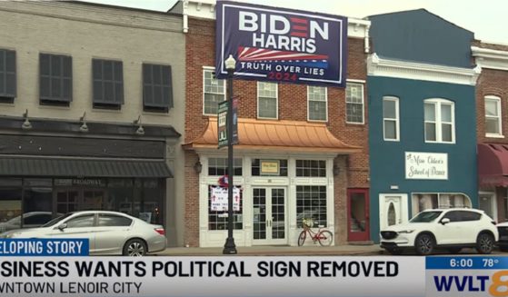 A sign supporting President Joe Bidena and Vice President Kamala Harris above a business in a Tennessee city.