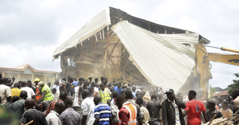 People and rescuers gather at the scene of a collapsed two-storey building Jos, Nigeria, Friday, July 12, 2024. At least 12 students have been killed after a school building collapsed and trapped them in northern Nigeria, authorities said on Friday.