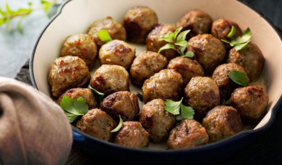 This image shows Swedish meatballs cooked in a cast iron pan.