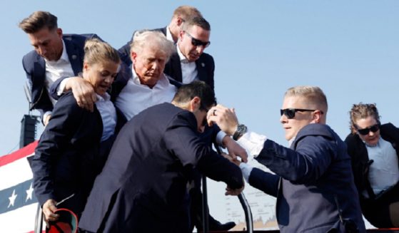 Former President Donald Trump is assisted offstage July 13 after a nearly successful assassination attempt in Butler, Pennsylvania. (Anna Moneymaker / Getty Images)