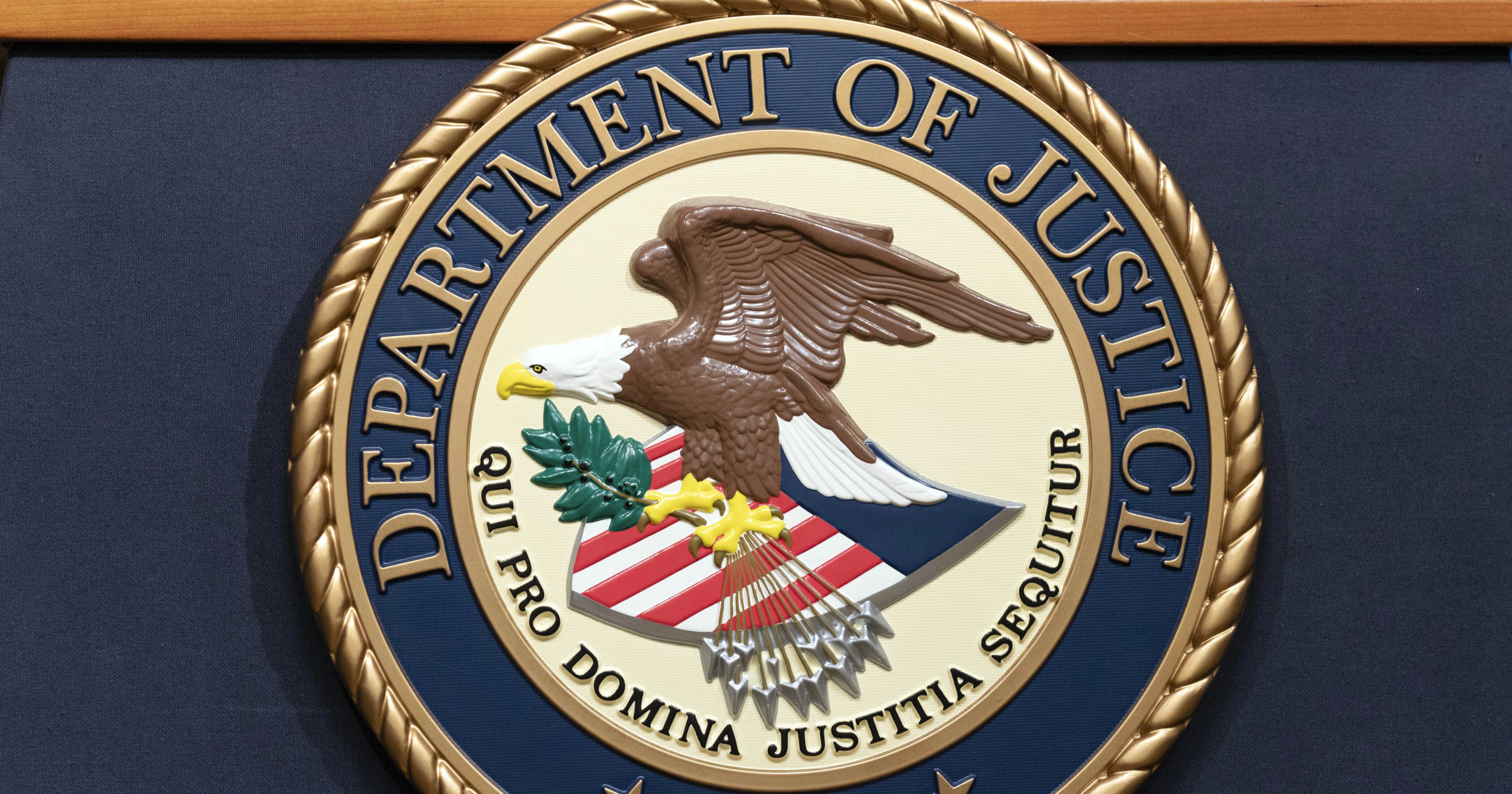 The Department of Justice seals is seen during a news conference at the Department of Justice in Washington, Tuesday, May 16, 2023. A federal grand jury in California has charged activist short seller Andrew Left with multiple counts of securities fraud, Friday, July 26, 2024, for a $16 million stock market manipulation scheme.