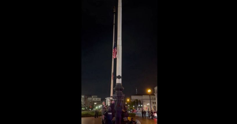 This X screen shot shows a number of government workers and officials raising the American flag after they had been torn down by protesters on July 24, 2024.