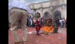 This X screen shot shows a scene from a video captured on July 24, 2024, where an unknown man saved a burning American flag from pro-Palestinian rioters.