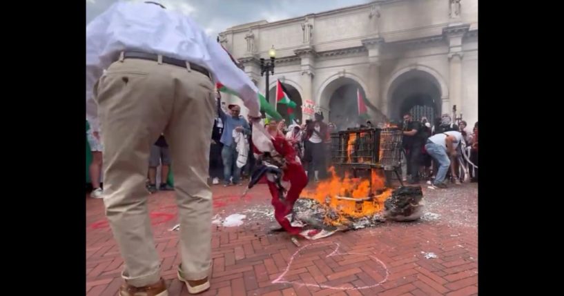 This X screen shot shows a scene from a video captured on July 24, 2024, where an unknown man saved a burning American flag from pro-Palestinian rioters.