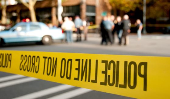This Getty stock image shows a police scene, with yellow police tape in the foreground.