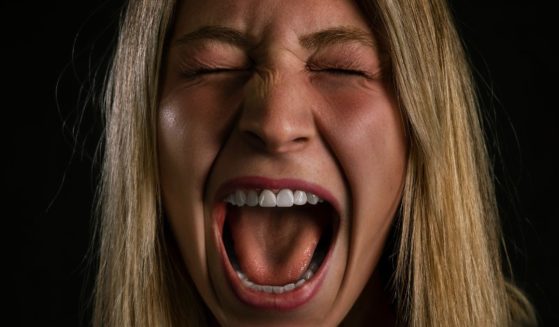 This image is a close up of a woman screaming.