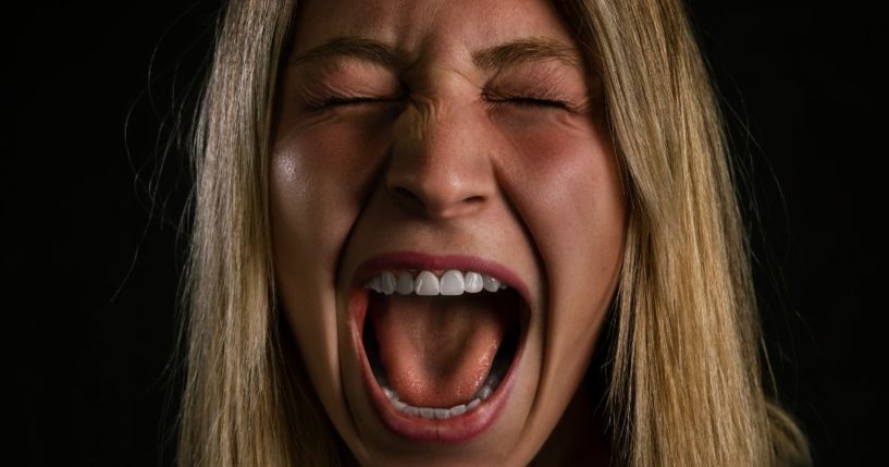 This image is a close up of a woman screaming.