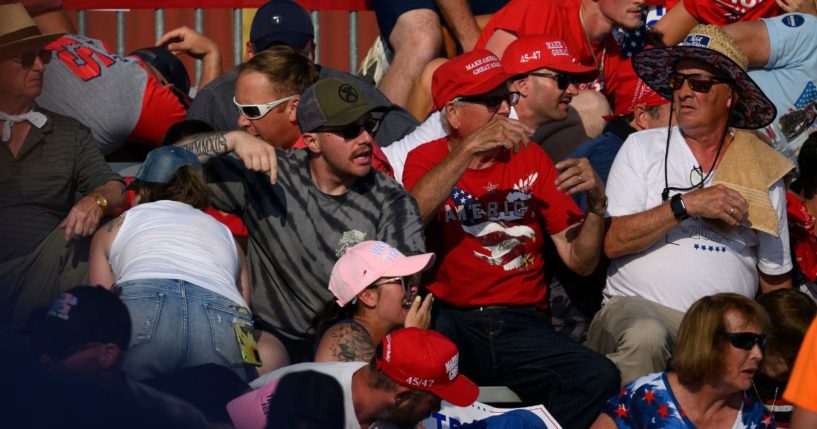 Attendees near where Corey Comperatore was struck call for aid moments after Thomas Matthew Crooks opened fire on former president Donald Trump during a campaign rally at Butler Farm Show Inc. on July 13, 2024 in Butler, Pennsylvania. Corey Comperatore, a 50-year-old retired firefighter, was killed and two others were severely injured in the assassination attempt on the former president.