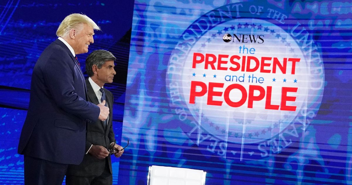 Then-US President Donald Trump poses with ABC New anchor George Stephanopoulos ahead of a town hall event at the National Constitution Center in Philadelphia, Pennsylvania on September 15, 2020.