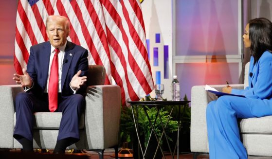 Former President and 2024 Republican presidential nominee Donald Trump, left, answers questions as moderator and journalist Rachel Scott, right, looks on during the National Association of Black Journalists annual convention in Chicago, Illinois, on July 31.