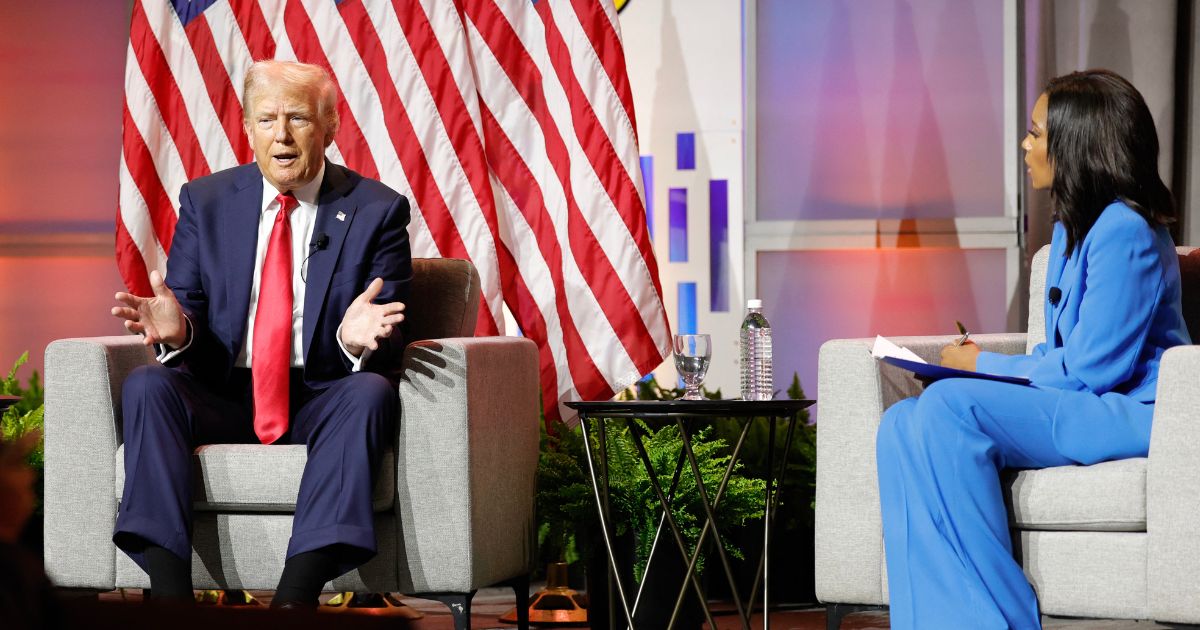 Former President and 2024 Republican presidential nominee Donald Trump, left, answers questions as moderator and journalist Rachel Scott, right, looks on during the National Association of Black Journalists annual convention in Chicago, Illinois, on July 31.