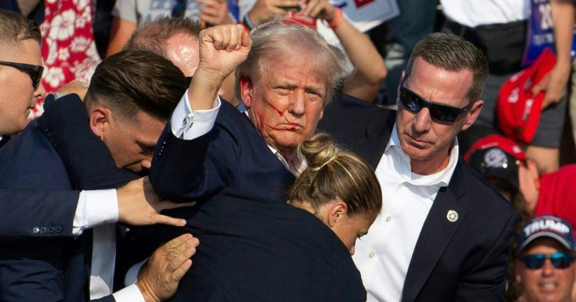 Republican candidate Donald Trump is seen with blood on his face surrounded by secret service agents as he is taken off the stage at a campaign event at Butler Farm Show Inc. in Butler, Pennsylvania, July 13, 2024.