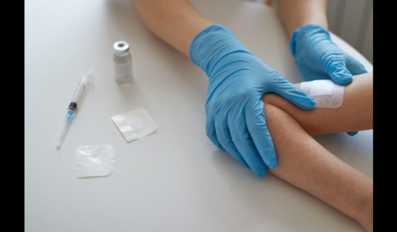 This Getty stock image shows a doctor applying a vaccination to a child.