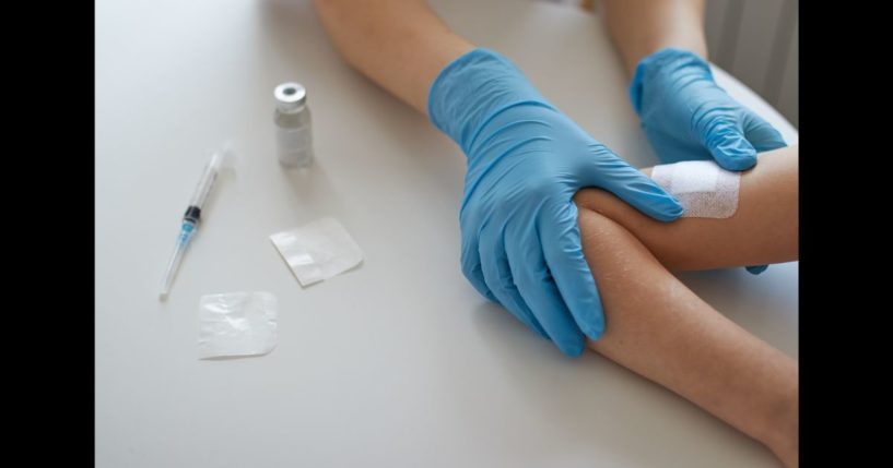 This Getty stock image shows a doctor applying a vaccination to a child.