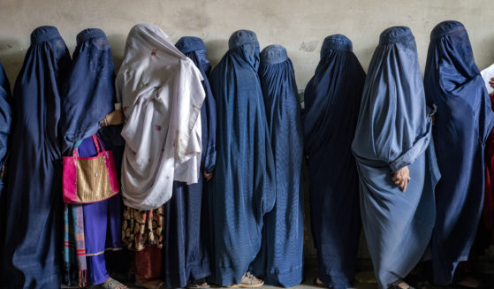 Afghan women wait to receive food rations distributed by a humanitarian aid group, in Kabul, Afghanistan, May 23, 2023. The Taliban Virtue and Vice Ministry had on May 7, 2022 ,said women in public must wear all-encompassing robes and cover their faces except for their eyes.