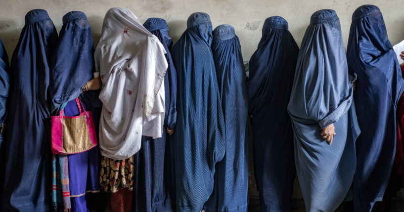 Afghan women wait to receive food rations distributed by a humanitarian aid group, in Kabul, Afghanistan, May 23, 2023. The Taliban Virtue and Vice Ministry had on May 7, 2022 ,said women in public must wear all-encompassing robes and cover their faces except for their eyes.