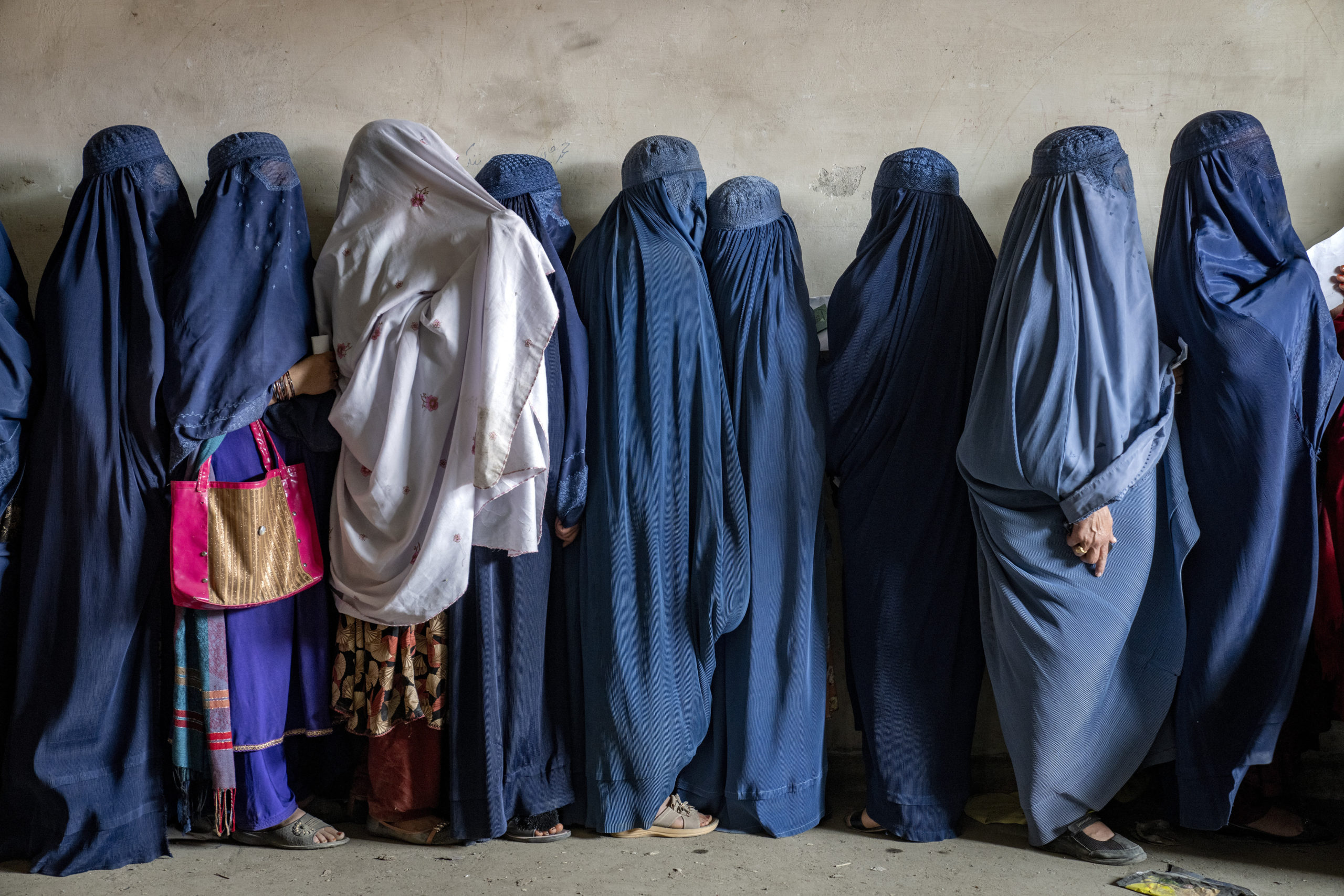 Afghan women wait to receive food rations distributed by a humanitarian aid group, in Kabul, Afghanistan, May 23, 2023. The Taliban Virtue and Vice Ministry had on May 7, 2022 ,said women in public must wear all-encompassing robes and cover their faces except for their eyes.